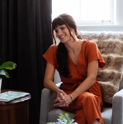 Greer (woman) sitting in armchair